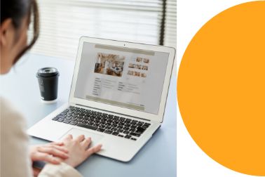 Woman working on her laptop next to an orange half circle