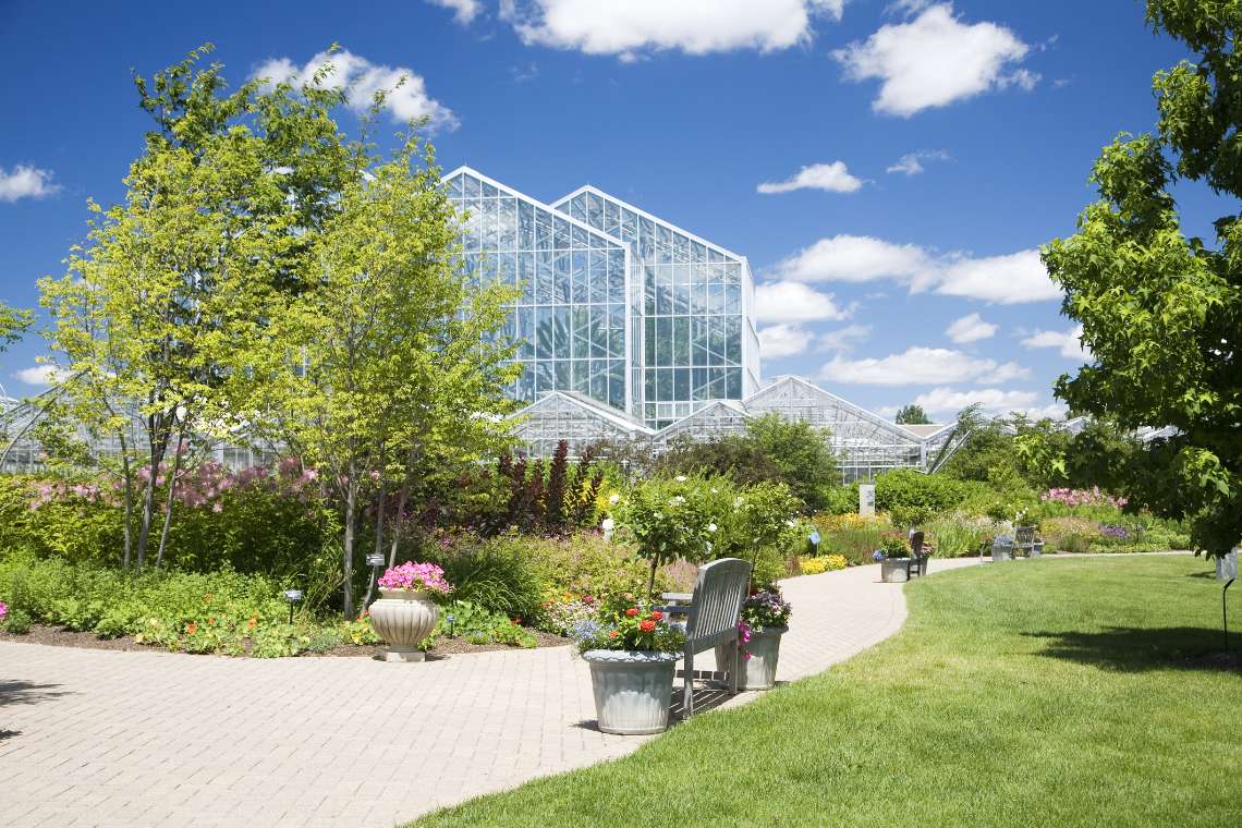 A huge greenhouse in the middle of a park